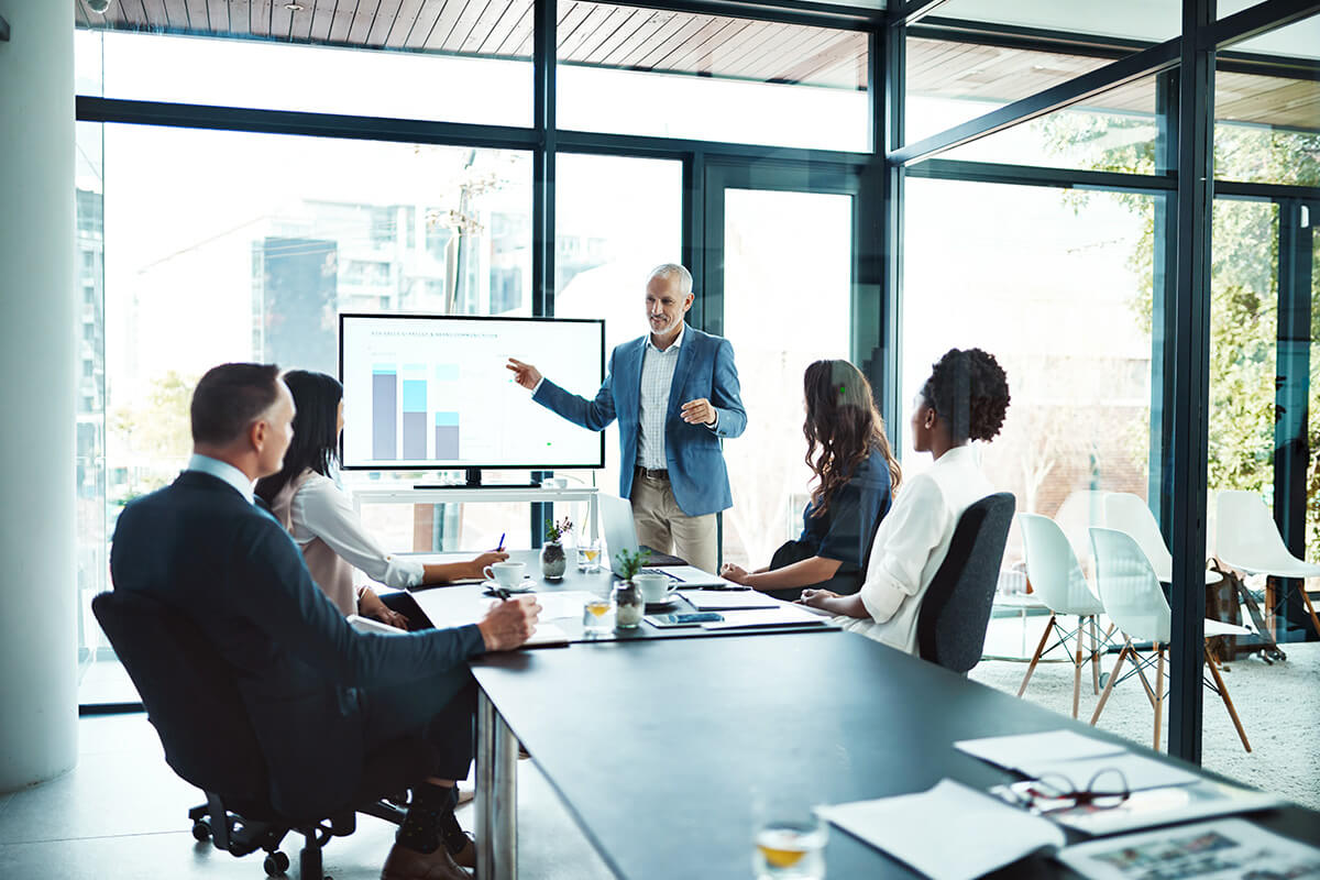 Meeting with a contract bar chart being shown on a screen.